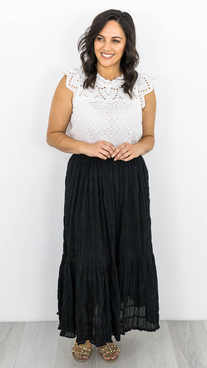 The Earl Skirt, easy to wear with an elastic waistband, tiers through the body and lined. The skirt has a textured material with a slight stretch. Sizes available  XS to XL. This skirt is true to size. 